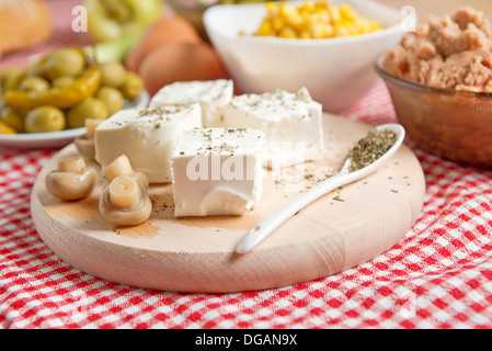 Il formaggio feta con funghi su un tavolo da cucina. Foto Stock