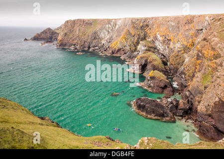 Kayakers in una grotta vicino a Mullion Cove sulla penisola di Lizard, Cornwall, Regno Unito. Foto Stock