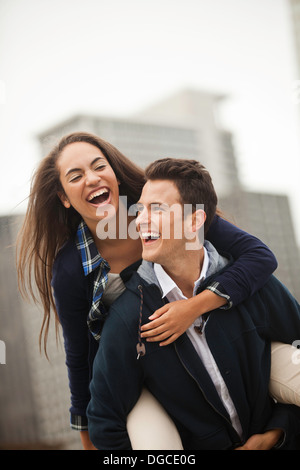 Giovane donna di trasporto su strada-ferrovia, ridendo Foto Stock