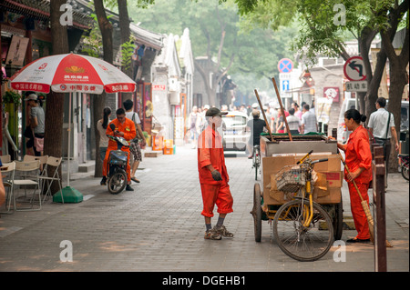 Gli operatori sanitari la pulizia della strada principale del Jing Yang Hutong di Pechino. L'Hutong fornire vi riportiamo di vita a Pechino. Foto Stock