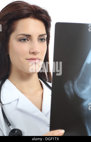 Bella donna medico cercando una radiografia di un ginocchio isolato su uno sfondo bianco Foto Stock