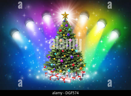 Christmas spotlights with rainbow colors as a festive magical abstract background of winter and new year celelebration with lights shinning on a decorated pine tree with gifts and a glowing star. Foto Stock