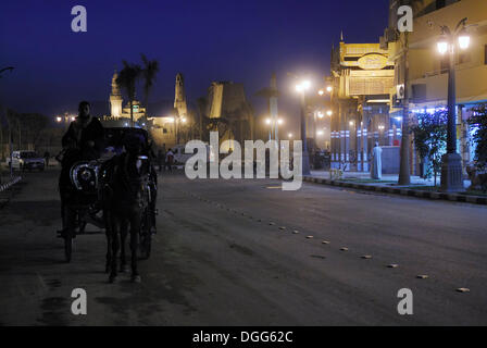 Carrozza trainata da cavalli nella città di Luxor di notte, Valle del Nilo, Egitto, Africa Foto Stock