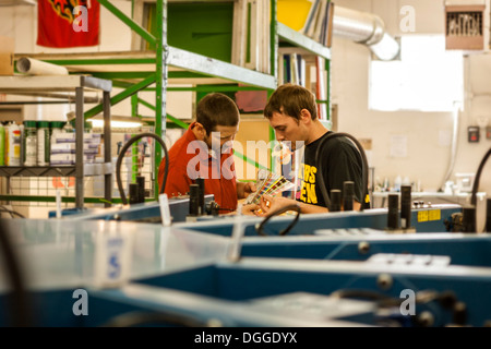 Controllo dei lavoratori i campioni di colore nella stampa di schermo di officina Foto Stock