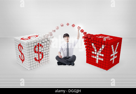 Un business uomo seduto tra i cubetti di valute Foto Stock