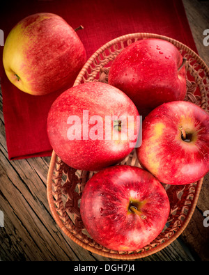 Organici freschi maturi frutti di Apple sul vecchio tavolo in legno con tovaglia in tela. Immagine in stile vintage Foto Stock
