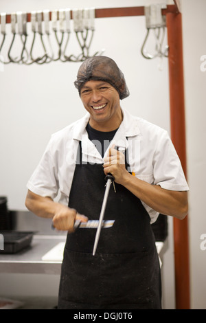 Macellaio coltello affilatura Foto Stock