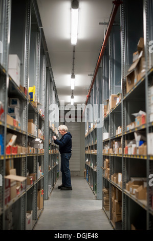 Magazzino maschio lavoratore selezionando la voce da scaffale Foto Stock