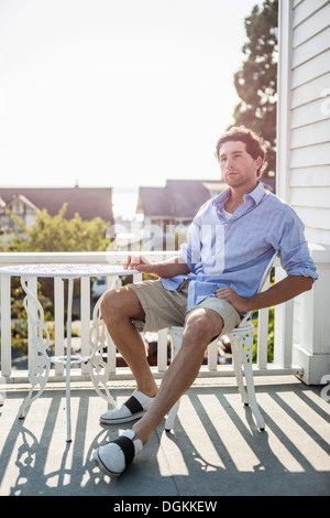 Stati Uniti d'America, Washington, Everett, Ritratto di giovane uomo rilassante sul balcone Foto Stock