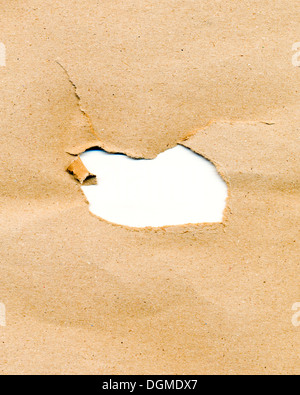 Foro nella carta kraft Foto Stock