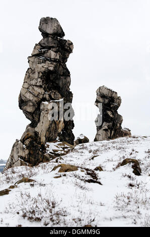 Due wild, robusto, bizzarre rocce, neve Teufelsmauer formazione rocciosa a Wedersleben, Neinstedt, northern Harz, Sassonia-Anhalt Foto Stock