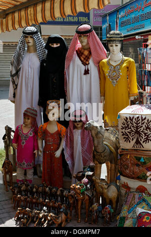 Mannequins indossando il tradizionale arabo abbigliamento per la vendita, per le donne, uomini e bambini, Deira, Vecchio Souk di Dubai, Foto Stock