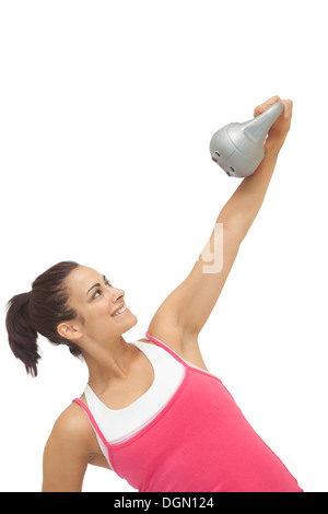 Allegro sportivo brunette holding grigio e kettlebell Foto Stock