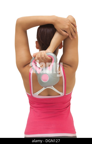 Vista posteriore del sporty brunette holding kettlebell Foto Stock
