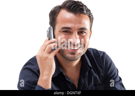 Uomo sorridente a parlare su un telefono mobile Foto Stock