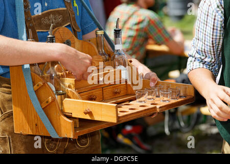 Uomo con un Hawker vassoio della vendita di liquori, Pfeifertag festival sul Niedergadenalm alp, Strobl, stato di Salisburgo Foto Stock