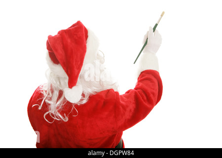 Babbo Natale utilizzando un artista della spazzola di vernice per dipingere una foto o un messaggio. Isolato elemento di design. Foto Stock