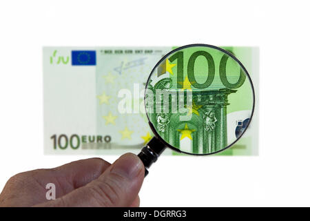 100 di banconote in euro al di sotto di una lente di ingrandimento immagine simbolica, osservazione dell'euro Foto Stock