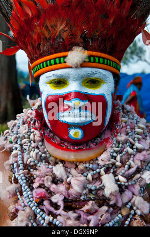 La donna in un colorato costume decorato con vernice di faccia al tradizionale sing-sing raccolta, Hochland, Mount Hagen Foto Stock