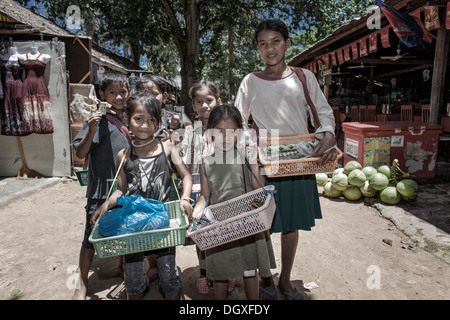 Bambini falchi di strada al lavoro che vendono souvenir ai turisti a Angkor Wat, Siem Reap, Cambogia S. E. Asia Foto Stock