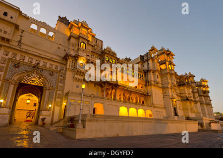 Il cortile e la città illuminata Palazzo del Maharana di Udaipur, Udaipur, Rajasthan, India Foto Stock