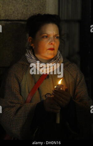 Dublino, Irlanda. 28 ott 2013. Una donna è raffigurato, tenendo in mano una candela. La gente ha commemorato l'anniversario della morte di Savita Halappanavar con una veglia a lume di candela in Dublino. Savita è morto un anno fa a Galway dopo che è stato negato un aborto durante un aborto spontaneo. La veglia è stato parte di diverse in Irlanda. Credito: Michael Debets/Alamy Live News Foto Stock