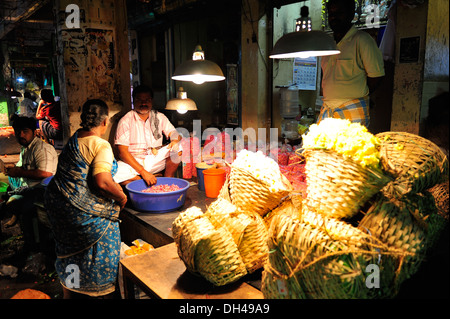 Uomo che vendono fiori shop Koyambedu Flower Market Tamil Nadu India Asia Foto Stock