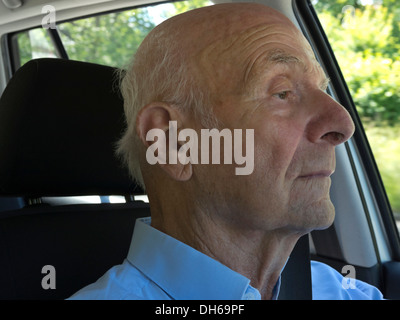Il vecchio uomo alla guida di una vettura, focalizzato e concentrato Foto Stock