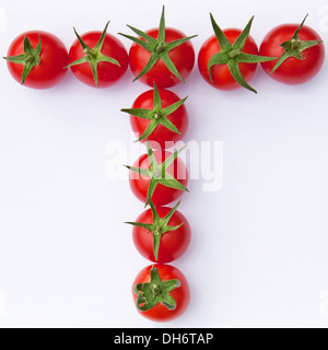 Pomodori maturi formando la loro iniziale English lettera 'T' Foto Stock