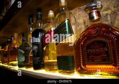 Bottiglie di alcolici vengono visti da accantonare in un cocktail bar in Brighton Foto Stock