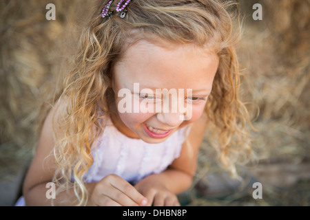 Una giovane ragazza in un granaio di ridere. Foto Stock