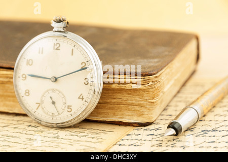 Libro antico e orologio da tasca Foto Stock