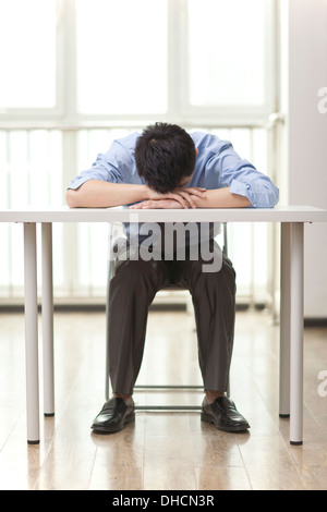 Ritratto di giovane imprenditore dormire in ufficio Foto Stock
