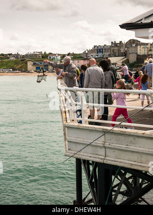 Famiglie attività di pesca del granchio off Cromer Pier in Norfolk Inghilterra Foto Stock