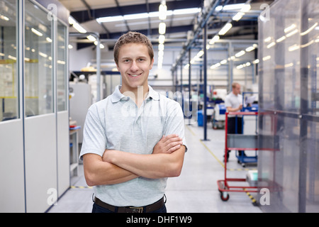 Ritratto di lavoratore con le braccia incrociate nella fabbrica di ingegneria Foto Stock