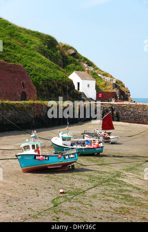 Blu barche da pesca sulla sabbia con un red sail e porto dietro. Foto Stock