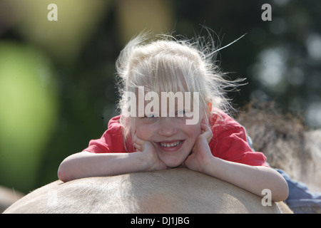 Sorridente ragazza distesa groppa fiordo norvegese cavallo Foto Stock