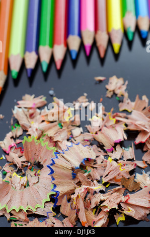 Matite multicolore e trucioli su sfondo nero Foto Stock