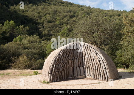 Logs impilati in un tradizionale carbone forno Foto Stock