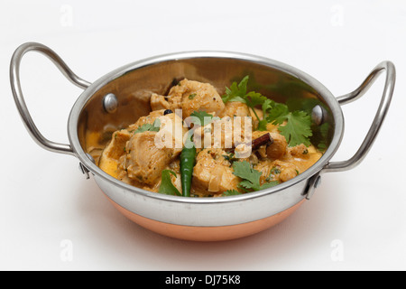 Vista ravvicinata di Balti chicken pasanda curry serviti, guarnite con foglie di coriandolo e un peperoncino rosso in un Indiano kadai ciotola Foto Stock