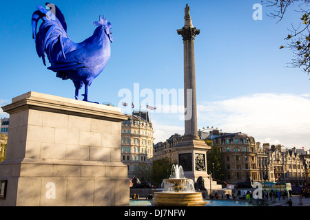 Gallo Blu scultura moderna sul plinto a Trafalgar Square a Londra con Nelson la colonna. Foto Stock
