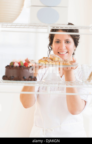 Ispanico baker holding dessert freschi Foto Stock