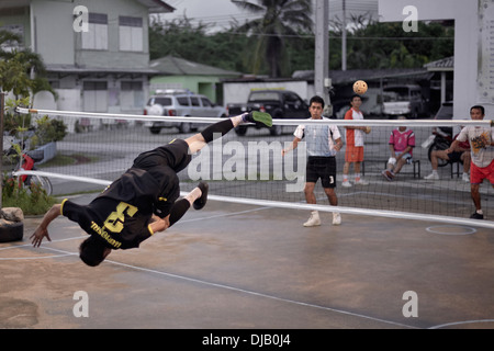 Atletismo estreme durante un gioco di Sepak Takraw. Tradizionale e Thai popolare gioco di calcio. Thailandia SUDEST ASIATICO Foto Stock