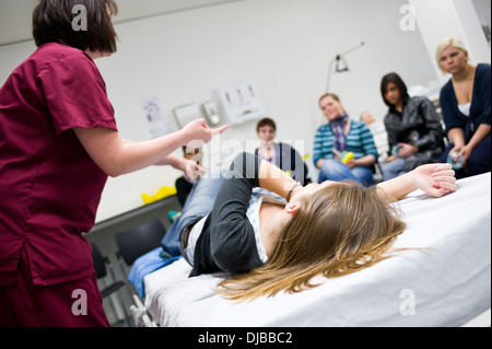 Studenti infermieri vengono insegnati da infermiere istruttore in le competenze cliniche lab Foto Stock