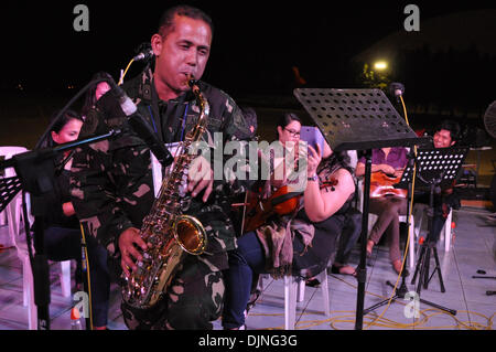 Pasay City a Manila, Filippine. Il 29 novembre 2013. Un Philippine Airforce officer unisce musicisti volontari nella riproduzione di musica all'interno del Villamor Airbase in Pasay City, a sud di Manila, Filippine il Venerdì, 29 novembre 2013. Credito: George Calvelo/Alamy Live News Foto Stock