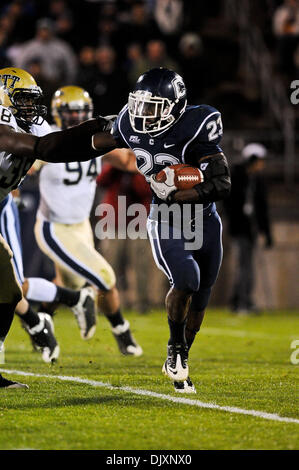 Nov. 11, 2010 - East Hartford, Connecticut, Stati Uniti d'America - Connecticut TB Jordan Todman (23) di bracci rigidi un Pitt defender correndo dietro l'angolo. A metà Connecticut conduce Pittsburgh 10 - 7 al campo Rentschler. (Credito Immagine: © Geoff Bolte/Southcreek globale/ZUMApress.com) Foto Stock