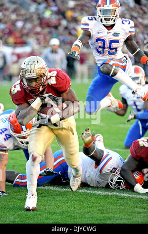 Nov. 27, 2010 - Tallahassee, Florida, Stati Uniti d'America - 27 Novembre 2010: . Stato della Florida RB Chris Thompson (23) trita il Gator difesa come UF SS Ahmad nero (35) salta oltre i compagni di squadra in un effor per la cattura di Thompson. FSU sconfitto Florida 31-7 a Doak Campbell Stadium di Tallahassee, Florida. (Credito Immagine: © Mike Olivella/ZUMAPRESS.com) Foto Stock