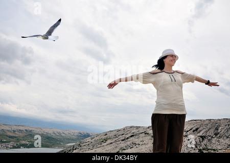 Ritratto di sorridere metà donna adulta con le braccia tese, Isola di Pag, Croazia, Europa Foto Stock