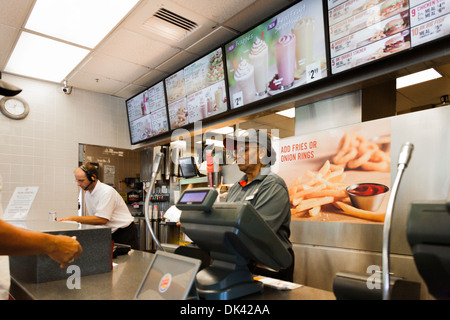 Dipendente tenendo un fast food ordine in un Burger King ristorante Foto Stock