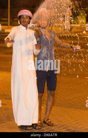 Dubai, EAU. 2° dicembre 2013. Il quarantaduesimo anniversario della fondazione Emirates è stato celebrato in Dubai. Il Burj al Arab facciata è stato coperto con la bandiera nazionale di colore e un omaggio alla scheiks e nella strada di Jumeirah Emirates giovani spruzzata automobili e persone. Credito: jonatha borzicchi editoriale/Alamy Live News Foto Stock